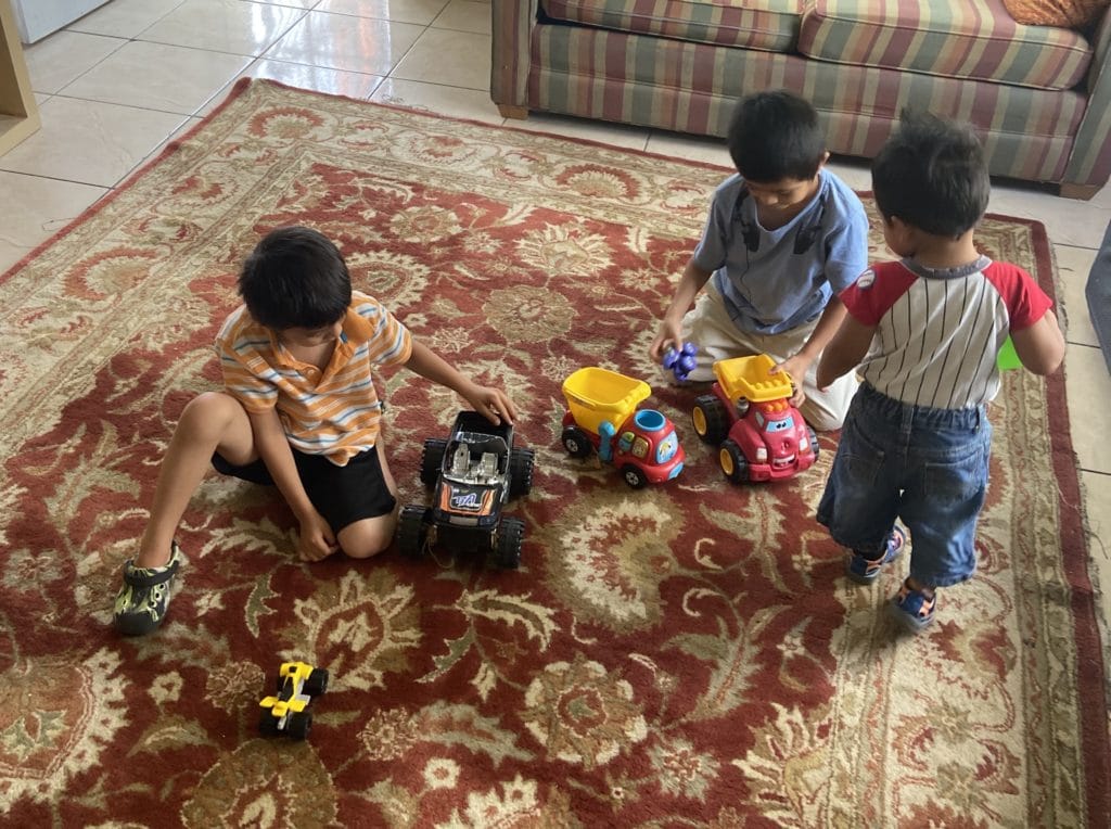 3 boys playing with trucks